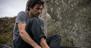 9 Scarpa Climbing Shoes Compared in One Table Climber pulling on Scarpa Drago climbing shoes at the base of a granite boulder
