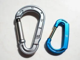 Comparison showing a rated safety climbing carabiner next to a non-rated accessory clip labeled "Not For Climbing".