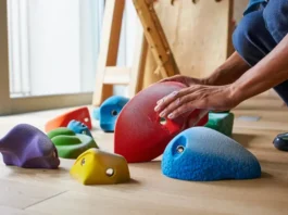 Diverse selection of top climbing hold sets laid out for choosing which ones to put on a home wall.