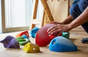 Which Climbing Holds for Your Home Wall? Top Sets Diverse selection of top climbing hold sets laid out for choosing which ones to put on a home wall.