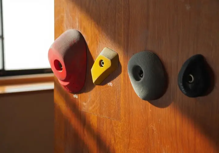 Understanding climbing hold types: close-up of jug, crimp, sloper, and pinch grip varieties.
