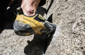 La Sportiva Climbing Shoes: Sizing & Fit Matrix Close-up of a La Sportiva climbing shoe standing on a small granite edge showing rubber deformation and fit tension.