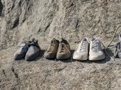 Rock Climbing Sneakers Are Really 3 Different Shoes Three types of footwear lined up on a granite ledge — a flat climbing shoe, an approach shoe, and a street sneaker