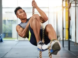 Guide on how to climb ropes using your legs: Climber demonstrating efficient technique with foot lock.