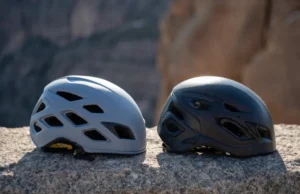 Lightweight vs. Durable: Best Rock Climbing Helmets Two rock climbing helmets, one lightweight and one durable, resting on a rock surface, illustrating the choice between lightweight and durable rock climbing helmets.