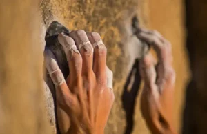 Climb Strong: Tape Fingers for Max Support & Health Climber's hands, one with fingers expertly taped for maximum support, gripping a rock hold, visually explaining how to tape fingers for climbing health and strength.