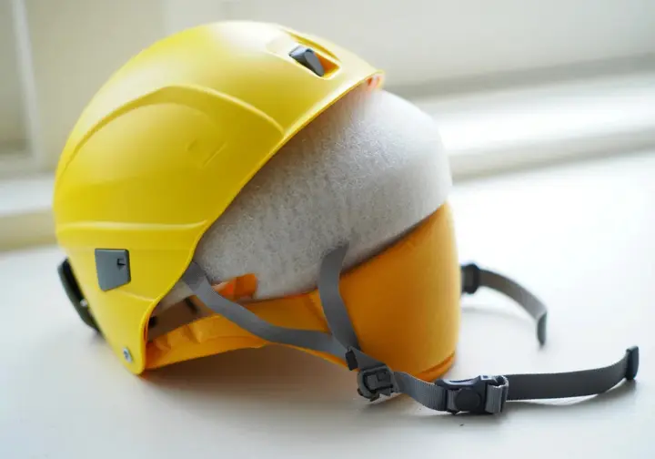 A detailed view of a climbing helmet's internal and external components, illustrating climbing helmet anatomy for understanding rock climbing helmet construction.