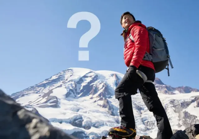 Mountaineering Rainier guide: Climber looking up at Mount Rainier, questioning if they are fit enough for the climb.