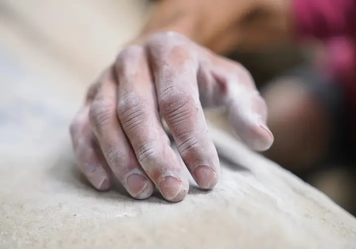 Detailed close-up of a climber's fingers, emphasizing their anatomical structure as crucial tools for climbing, relevant to understanding how to tape fingers.