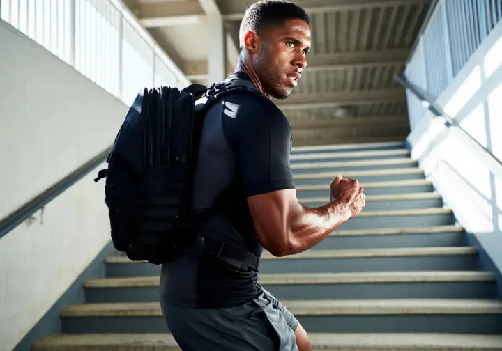 Building your Rainier engine: Person training by climbing stairs with a heavily weighted backpack.