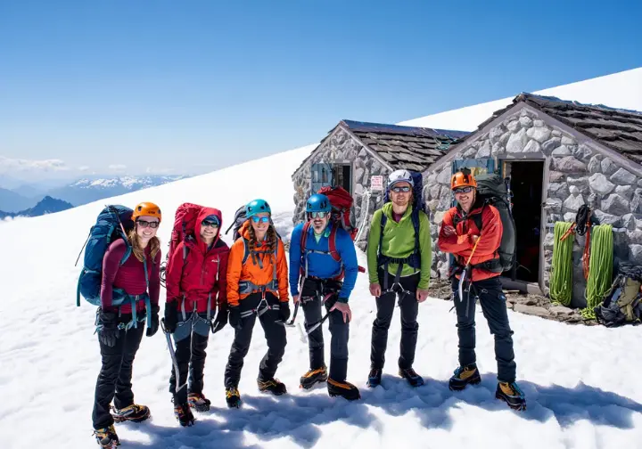 Meeting Rainier benchmarks: Guided climbing group arriving at Camp Muir after the ascent from Paradise.