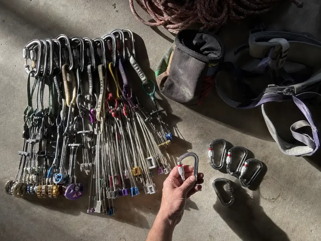 Full climbing rack laid out showing the ratio of locking to non-locking carabiners