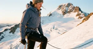 Why Half of Rainier Climbers Turn Around Roped climber on Disappointment Cleaver at dawn while mountaineering Rainier's glaciated upper slopes