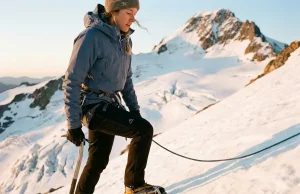 Why Half of Rainier Climbers Turn Around Roped climber on Disappointment Cleaver at dawn while mountaineering Rainier's glaciated upper slopes