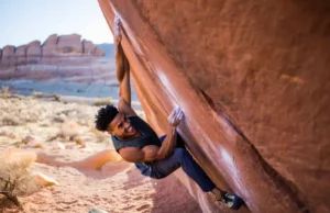 Bouldering Red Rocks: V0-VHard Insider Tips Climber at the crux of a sandstone boulder problem in Red Rocks, illustrating the article's coverage of bouldering red rocks from V0 to V-Hard with insider tips.