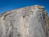 Unlock Half Dome: Yosemite Climbing In-Depth Beta Majestic panoramic view of Half Dome in Yosemite, its detailed granite face symbolizing in-depth beta for yosemite climbing half dome adventures.