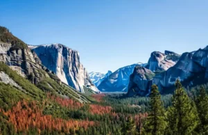 Yosemite Climbing: Routes, Permits & Secrets Guide Panoramic view of Yosemite Valley highlighting El Capitan and Half Dome, representing a guide to Yosemite climbing routes, permits, and secrets.