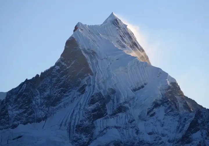 Close-up of an iconic, snow-covered Peruvian peak, symbolizing the challenge of choosing a summit for mountaineering in Peru.