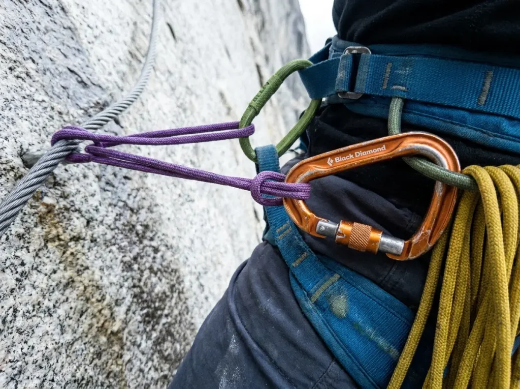 Prusik and locking carabiner rigged on a single Half Dome cable during the cables-down season