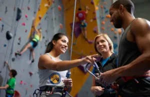 Choosing Your CWI Certification: AMGA, CWA, PCIA Guide Instructor guiding students on CWI certification choices (AMGA, CWA, PCIA) for climbing wall instructor certification.