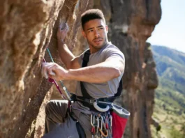 Climber experiencing elbow pain while rock climbing, needing diagnosis, treatment, and prevention for elbow pain from rock climbing.