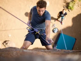Climber mastering top rope climbing techniques, showcasing knots and commands, essential for understanding what is top rope climbing.