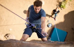 Master Top Rope Climbing: From Knots to Command Climber mastering top rope climbing techniques, showcasing knots and commands, essential for understanding what is top rope climbing.