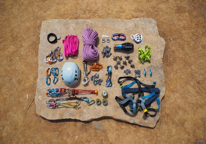 A flat lay of an essential trad climber's rack, including cams, nuts, and slings, crucial for understanding what is trad climbing.