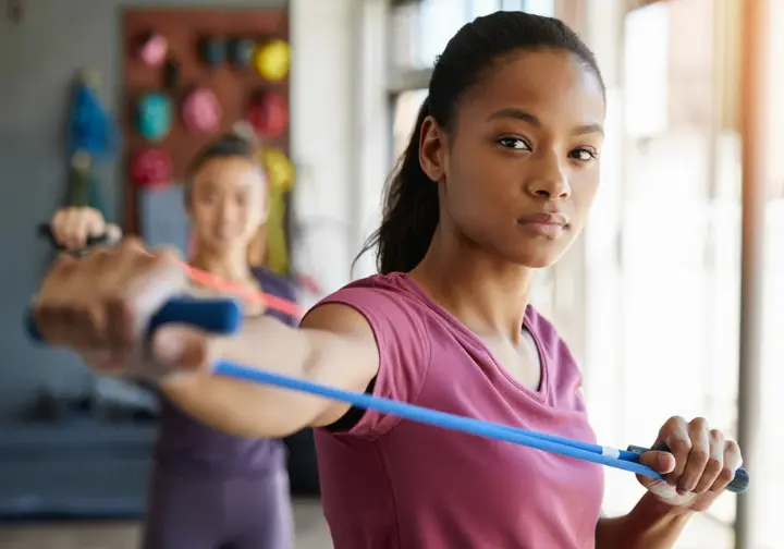 Preventing future elbow pain from rock climbing: female climber strengthening antagonist muscles to stay strong and climb smart.