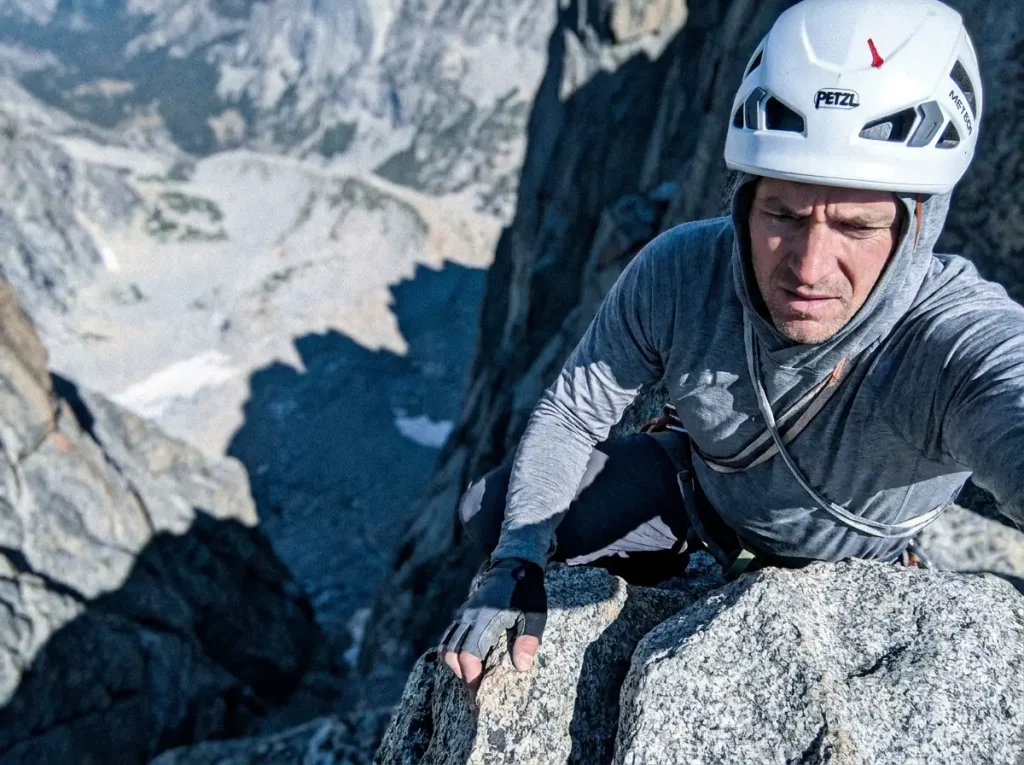 Climber at the Notch on Mount Whitney looking down the steep drop on the far side