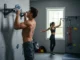 The Climber’s Pull Up Bar Guide: Best Bars & Moves Two climbers, a male and a female, training with different pull-up bars in a home gym setting, illustrating a comprehensive guide to pull-up bars for climbers.