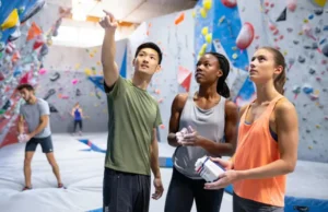 Master Bouldering Basics: Top Tips for New Climbers Master bouldering basics: diverse new climbers engaging at an indoor gym, illustrating top tips for beginners.