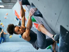 Master core exercises for bouldering: diverse female climber showcasing core strength on a steep overhang to climb stronger.