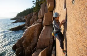 Master Maine Rock Climbing: Acadia, Trad & Sea Cliffs Master Maine rock climbing: diverse female climber on an Acadia sea cliff, highlighting trad climbing.