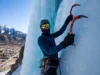 Master Ouray Ice Climbing: Park, Routes & Conditions Mastering Ouray ice climbing: climber on a spectacular ice route in the Ouray Ice Park, with the town and San Juan Mountains in view, detailing park, routes, and conditions.