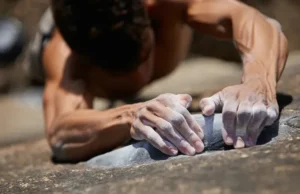 Master Rock Climbing Finger Training: Strength & Health Mastering rock climbing finger training: close-up of strong, chalked fingers gripping a rock hold, emphasizing strength and health.