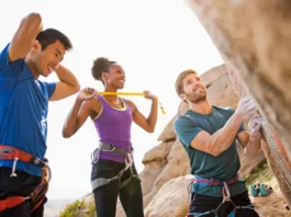 Mastering your rock climbing warm up: diverse climbers performing exercises to prevent injury now.