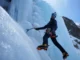 Master Training for Ice Climbing: Strength & Endurance Mastering training for ice climbing: climber showcasing strength and endurance by swinging an ice tool into a steep blue ice formation.