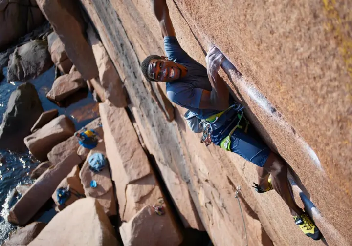 Acadia National Park, crown jewel of Maine rock climbing: diverse climber on a classic granite route.