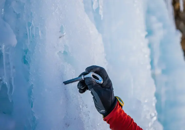 Decoding the ice: understanding Lee Vining ice climbing routes, walls, and grading systems with a close-up of screw placement.