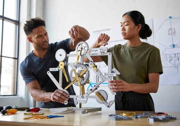 Deconstructing rock climbing performance: diverse climbers assembling a model with components like strength, power, and endurance to find the best exercise.