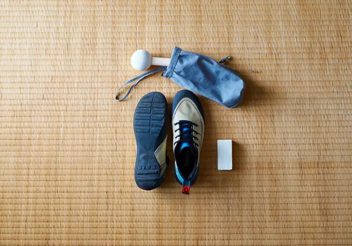 Essential bouldering equipment for beginners: flat lay of climbing shoes and chalk, key gear tips for new climbers.