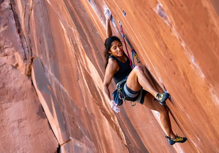 Understanding Red Rock Canyon as a climber's paradise: female climber on a featured Aztec Sandstone route.