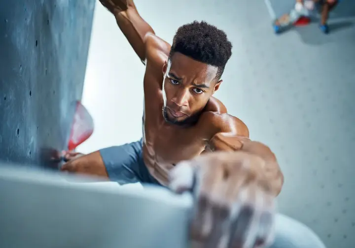 The unshakable foundation: core principles of climbing strength demonstrated by a climber's controlled lock-off, key for strength exercises.