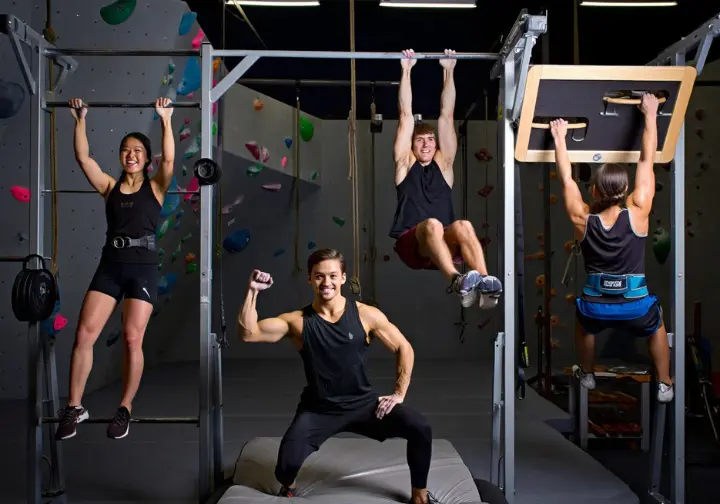 Building your climbing engine: diverse climbers performing key strength exercises for climbing like pull-ups and squats.