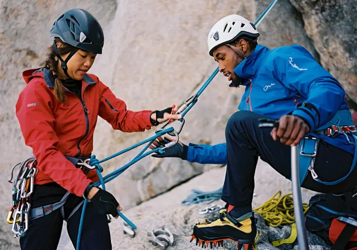 Essential skills and knowledge for tackling the best US mountains to climb: diverse climbers practicing technical rope skills in an outdoor training setting.