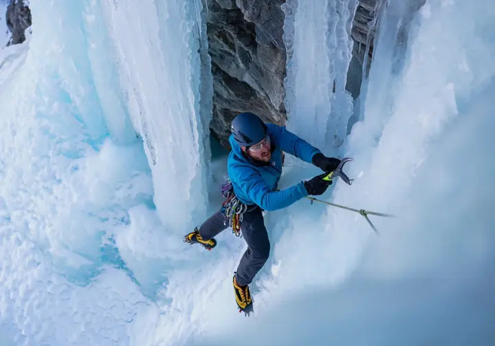 Conquering classic Lake Willoughby ice climbing routes: climber on an iconic, steep multi-pitch ice formation.