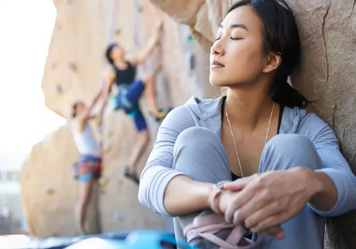Mental prep and avoiding common rock climbing warm up mistakes: climber focusing while another rushes.