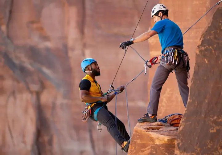 Safety first in Red Rock Canyon: diverse climbers responsibly navigating hazards on a multi-pitch route.