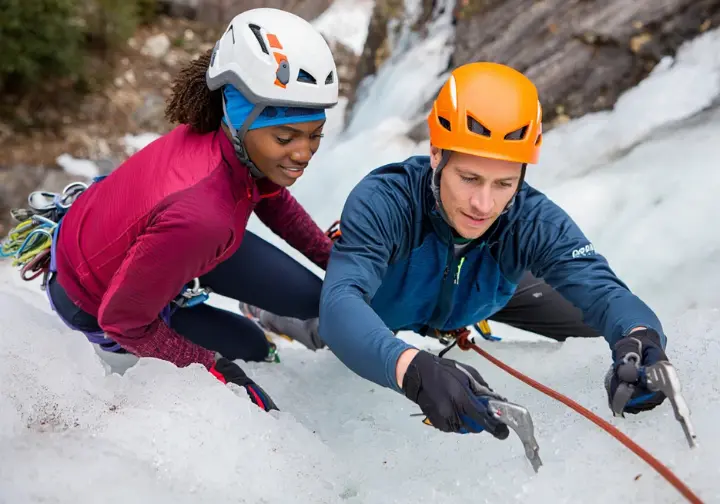 Guided ice climbing ascents and instruction at Lake Willoughby: certified guide teaching techniques to a client.